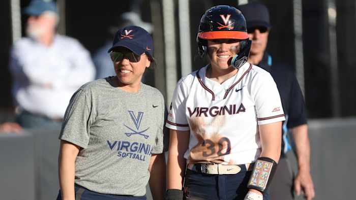 Joanna Hardin and Gabby Baylog talk on third base during the Virginia softball game against Longwood at Palmer Park.